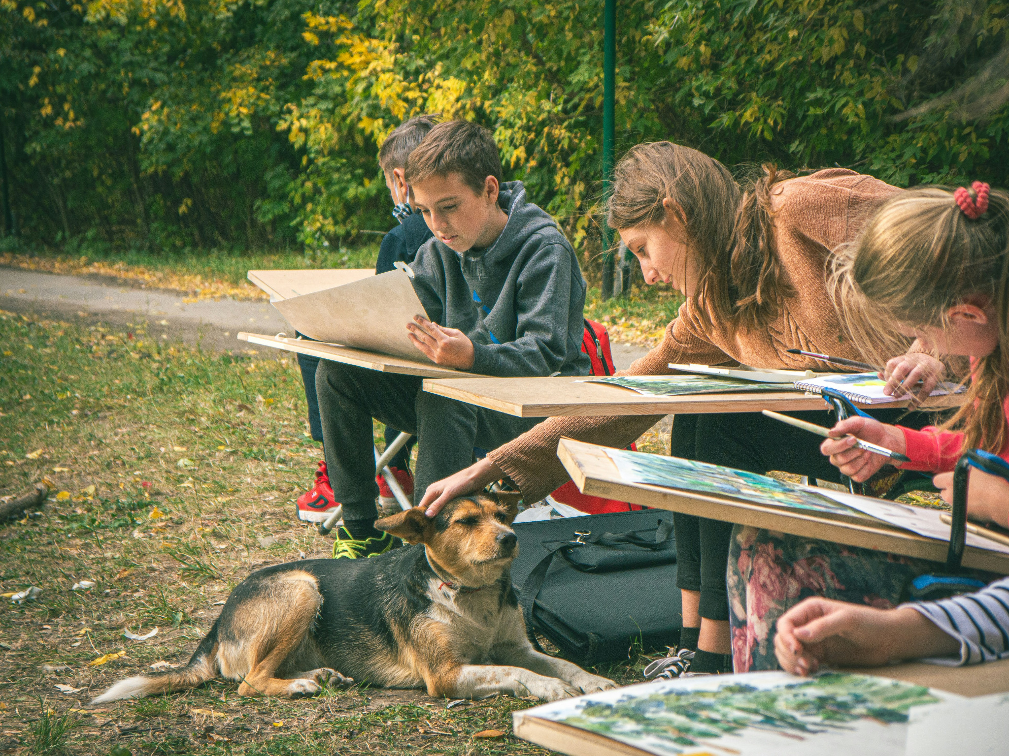 Children learning and creating together in an outdoor setting